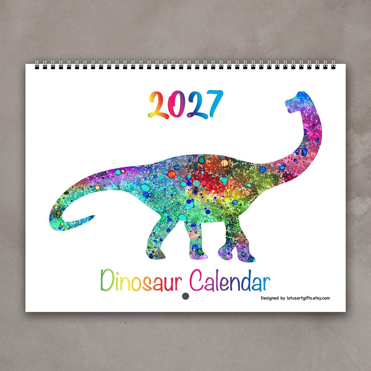 Cover of the 2027 kids’ dinosaur wall calendar with a multicolor watercolor prehistoric animal illustration