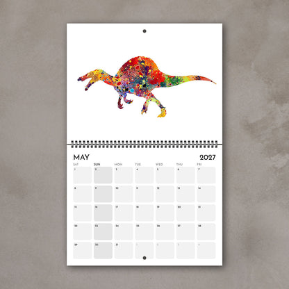 May 2027 kids’ calendar page with a colorful watercolor dinosaur above the date grid