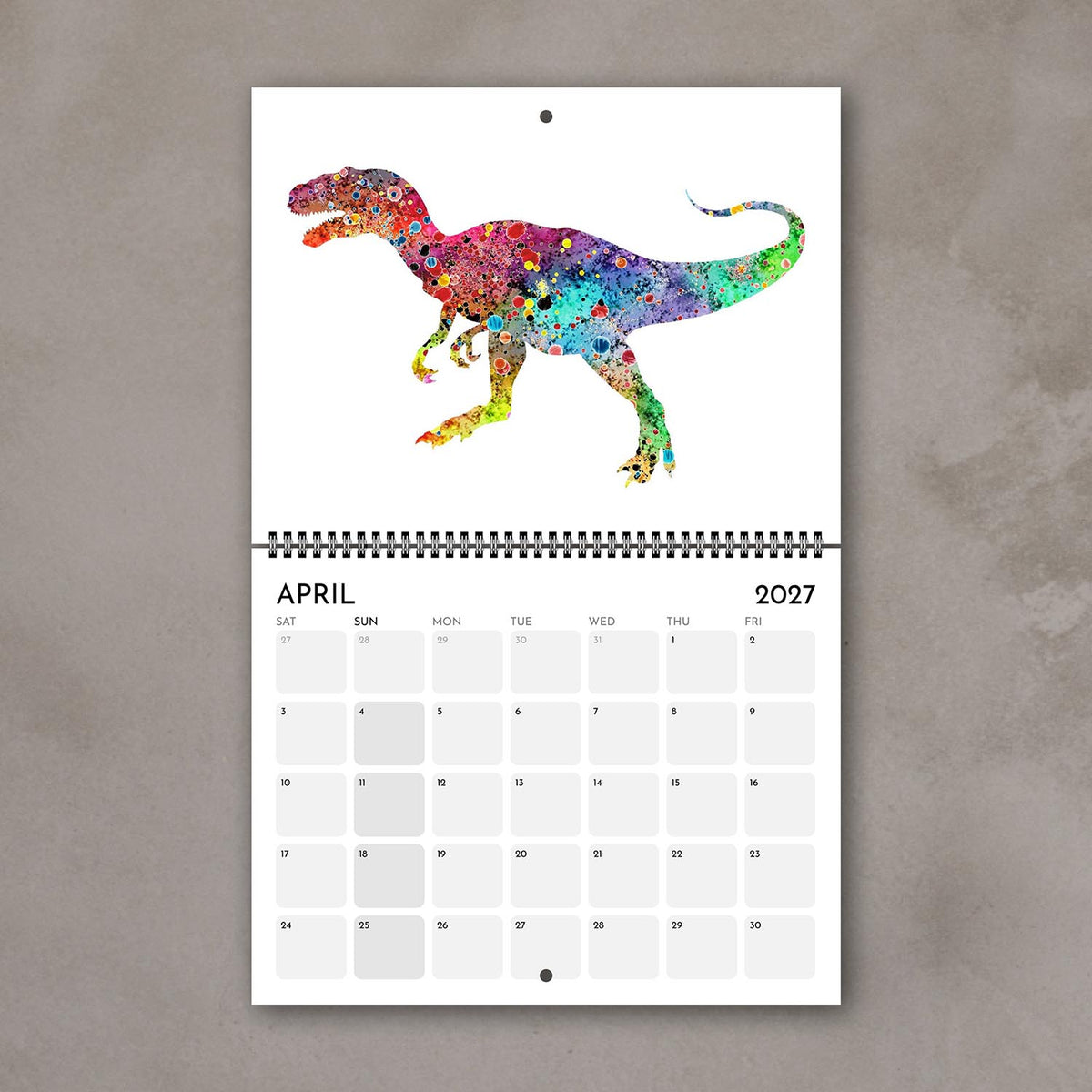 April 2027 dinosaur wall calendar page with multicolor watercolor art for kids who love prehistoric animals