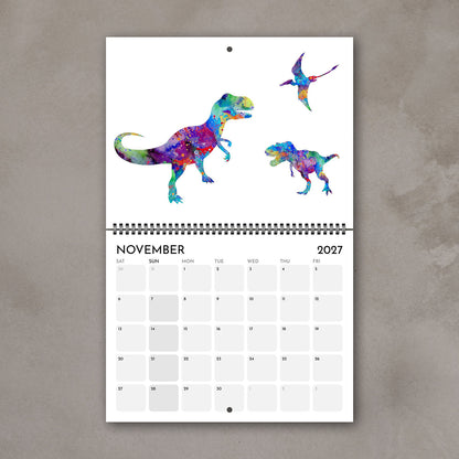 November 2027 wall calendar page featuring several illustrated watercolor dinosaurs for kids’ room