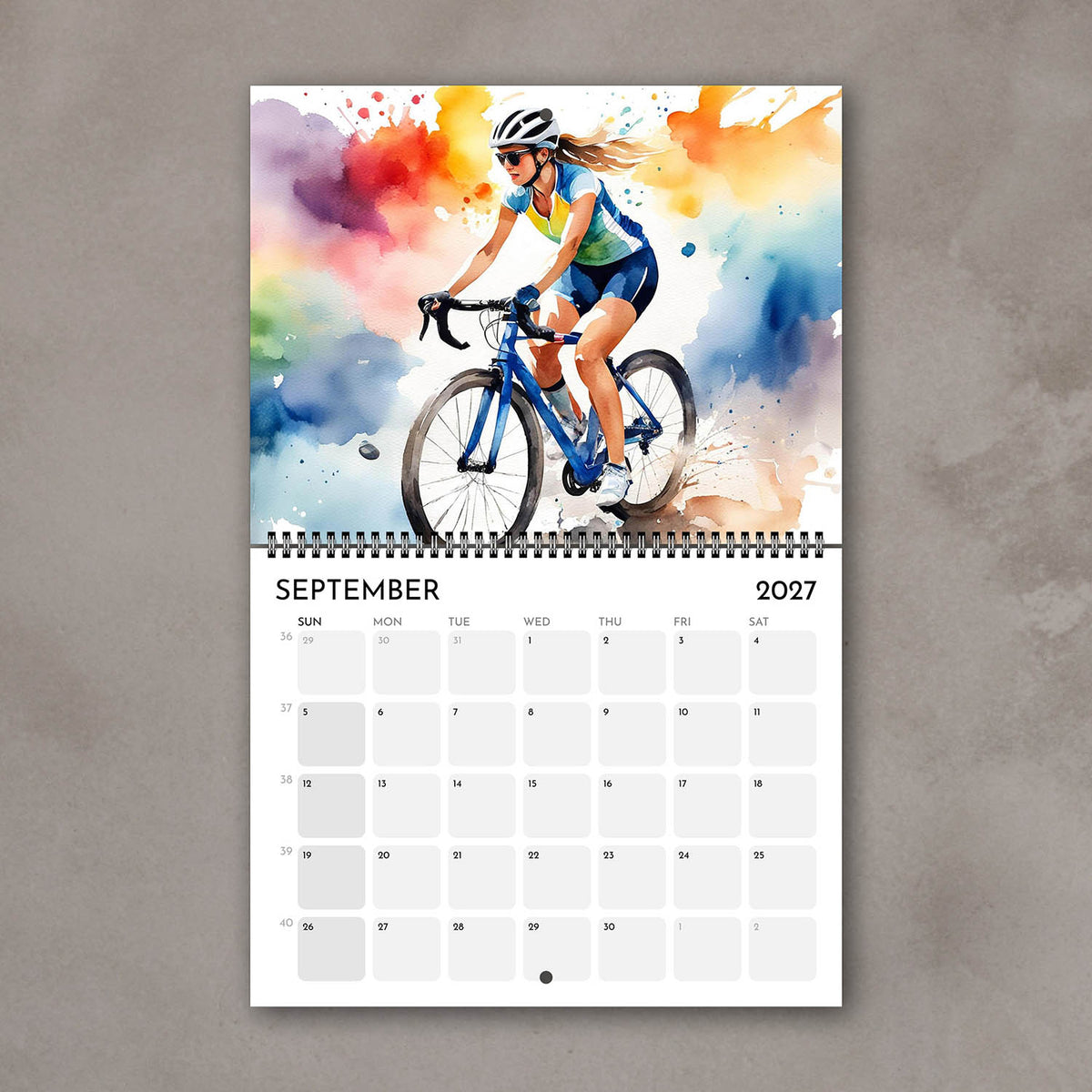 2027 Girls sports watercolor wall art calendar September page with cycling girl illustration in multicolor tones