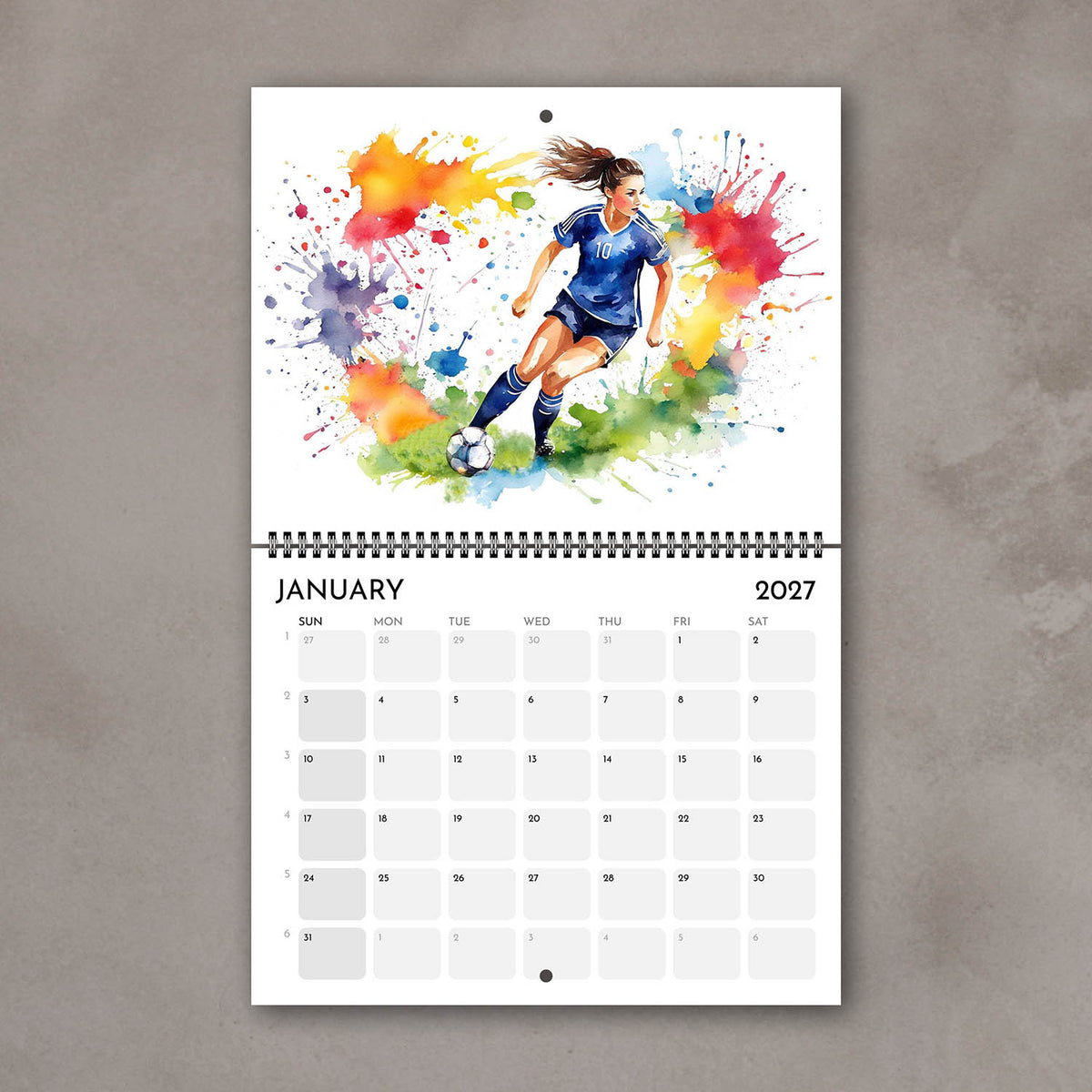 2027 Girls sports watercolor wall art calendar January page, soccer girl illustration with bright multicolored splashes