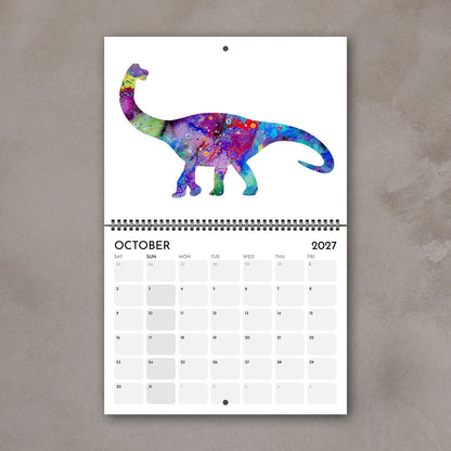 October 2027 dinosaur kids’ wall calendar page with a purple and blue watercolor illustration