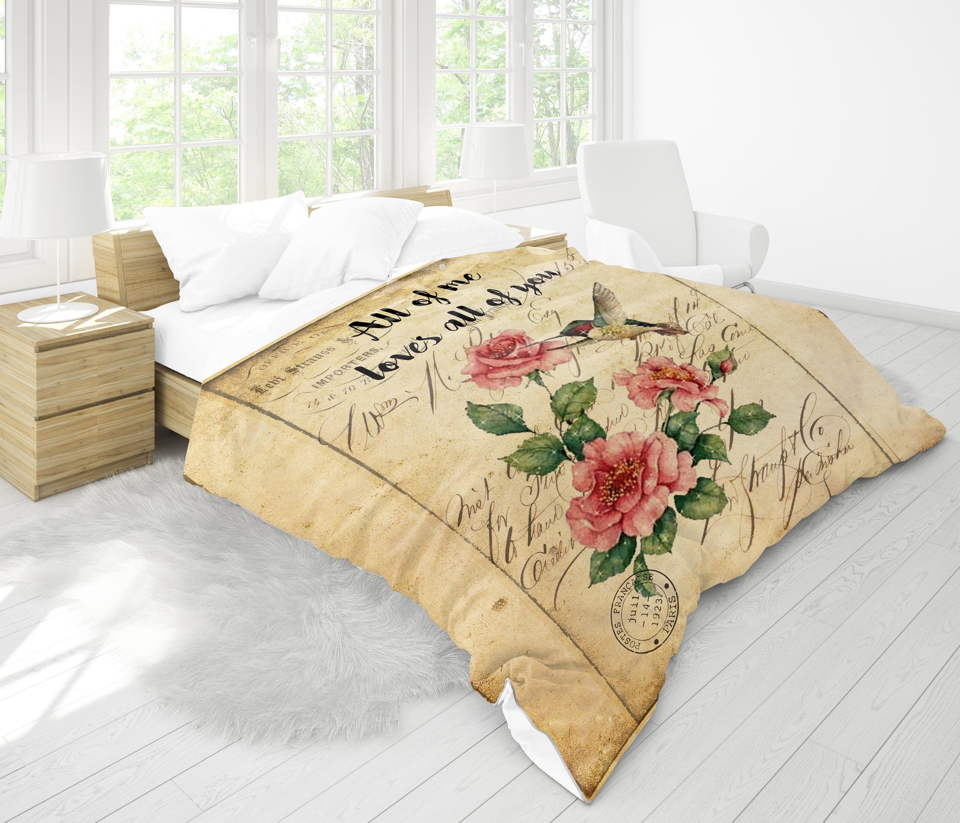 Roses hummingbird comforter folded - vintage style floral gift close-up on white table