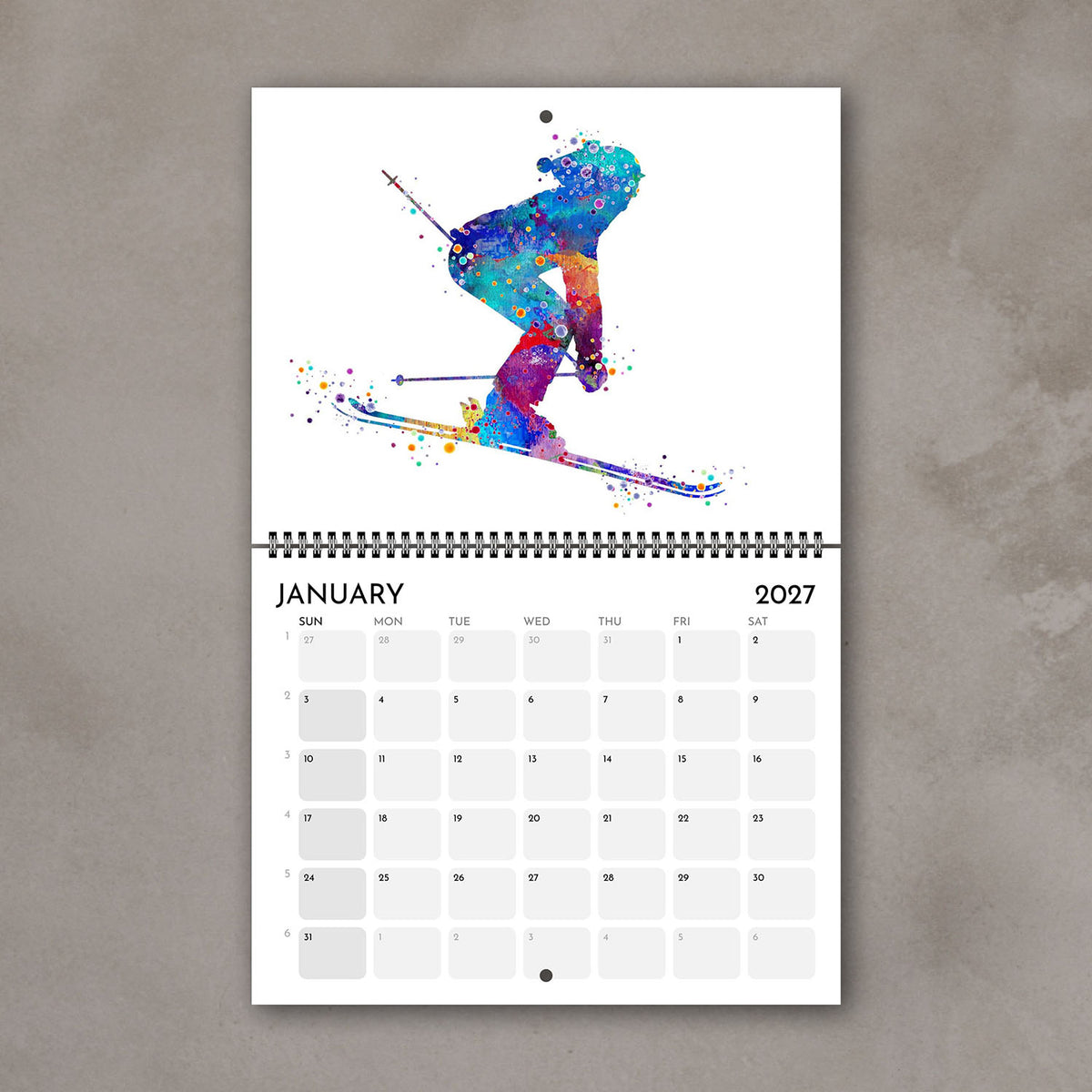 2027 sports watercolor wall calendar January page with skiing design, planner for girl athletes and girls' room decor
