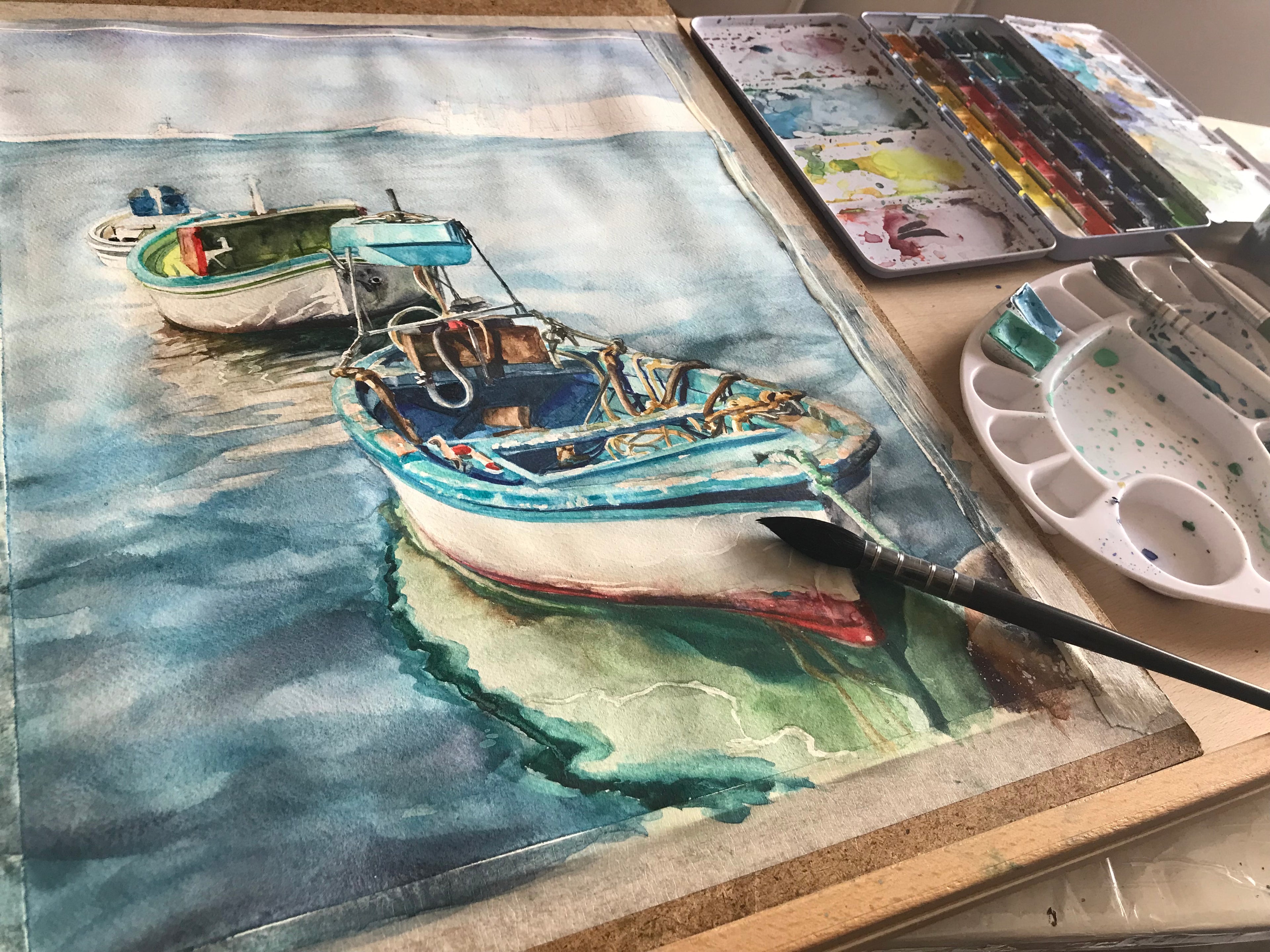 Watercolor painting of a boat on a dock with art supplies.
